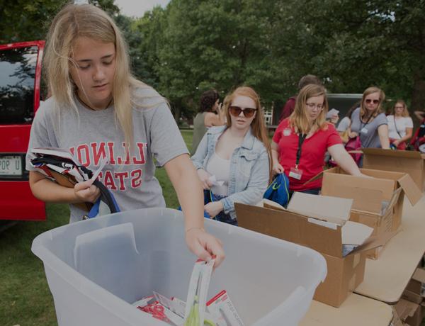 Students collecting school supplies on the quad.